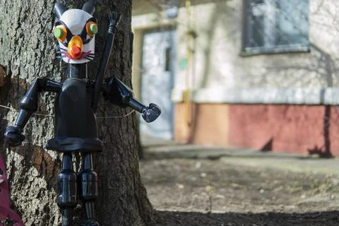 Doll made of empty plastic bottles near a tree. plastic recycling concept. Stock Photos