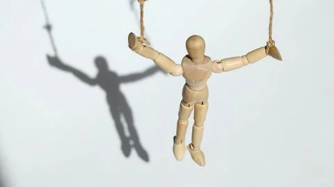A doll on a rope weighs on a white background and a shadow from it Stock Footage 274024405