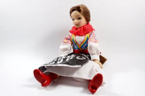 Doll sits on a white background Stock Photos