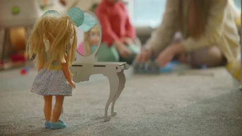 Doll stands at toy table mirror, mom and daughter playing at nursury background Stock Footage 235586258