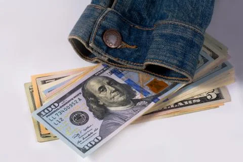 Dollar and denim jacket. Stock Photos