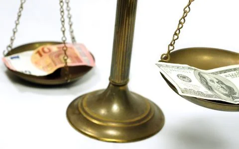 Dollar and Euro notes on scale Stock Photos