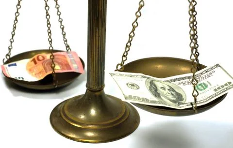 Dollar and Euro notes on scale Stock Photos