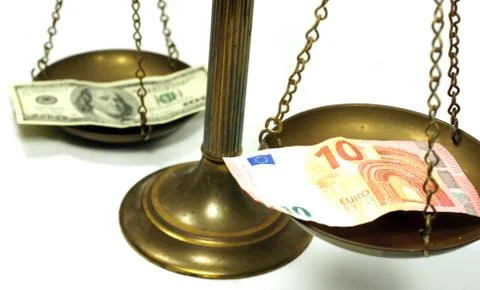Dollar and Euro notes on scale Stock Photos