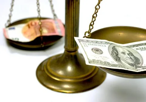 Dollar and Euro notes on scale Stock Photos