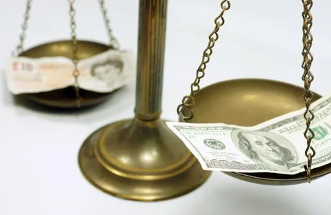 Dollar and Pound notes on scale Stock Photos