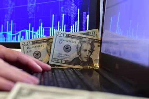 Dollar banknotes on blurred background of computer screen Stock Photos