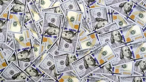 Dollar banknotes falling one by one on table surface covered with money Video stock 71028116