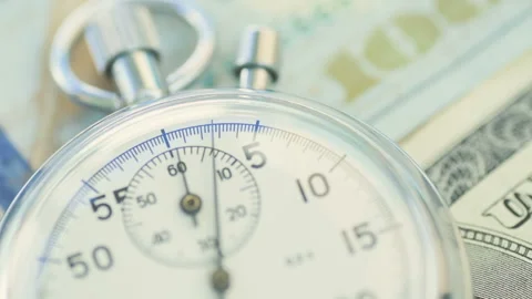 Dollar banknotes flying over the stopwatch dial. Stock Footage 156301177