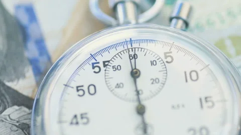 Dollar banknotes flying over the stopwatch dial. Stock-Footage 156301184