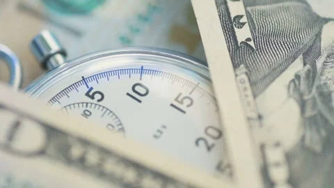 Dollar banknotes flying over the stopwatch dial. Stock Footage 156301216