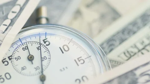 Dollar banknotes flying over the stopwatch dial. Stock-Footage 156301218