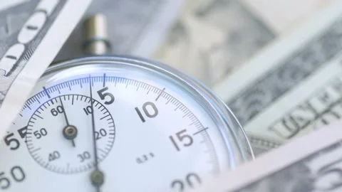 Dollar banknotes flying over the stopwatch dial. Stock-Footage 156301232