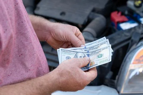 Dollar banknotes in hands of a driver Stock Photos