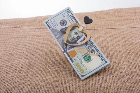 Dollar banknotes with a heart clip on a string Stock Photos