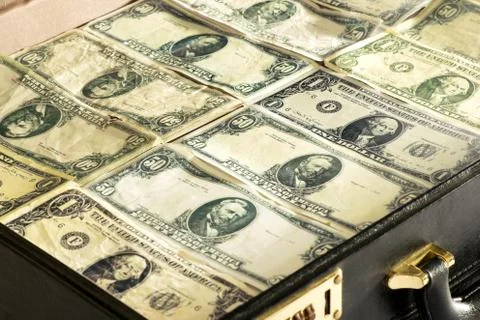 Dollar banknotes packed into a briefcase or bag Stock Photos