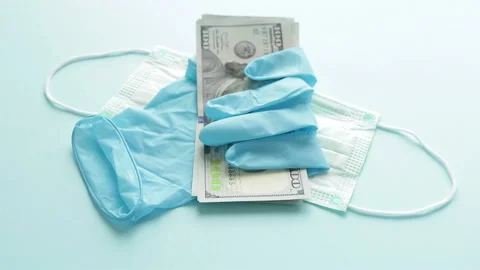 Dollar banknotes rubber glove protective medical mask  panning shot Stock Footage 126697903