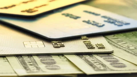 Dollar bill banknotes with plastic credit cards rotating on the shopper table Stock Footage 163883567