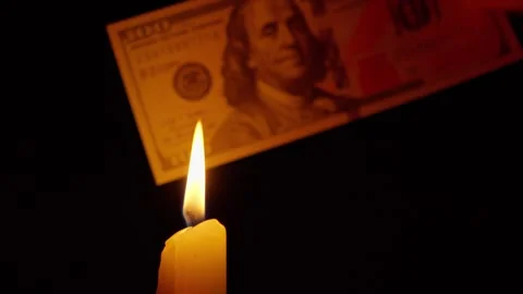 Dollar bill burning in candle flame close-up Stock Footage 345022430