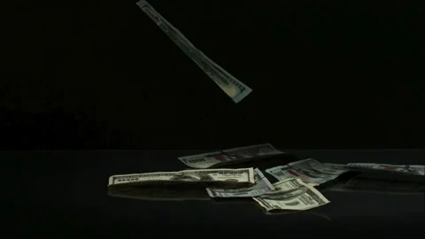 Dollar bill falling and landing on pile of cash Stock Footage 327632160