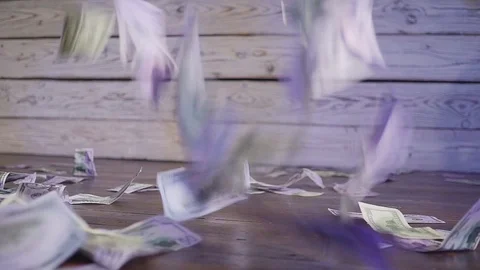 Dollar bill notes falling through the air on a wooden floor and a wall an 스톡 동영상 94744813