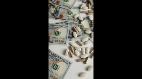 Dollar bills and various pills and capsules closeup video.  Stock Footage 318897347