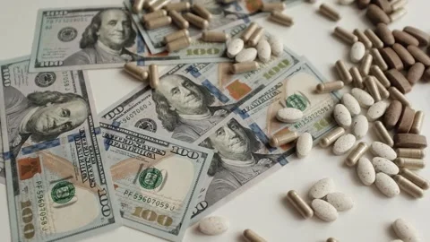 Dollar bills and various pills and capsules closeup video.  Stock Footage 318897378