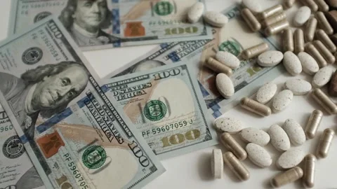Dollar bills and various pills and capsules closeup video.  Stock Footage 318897553