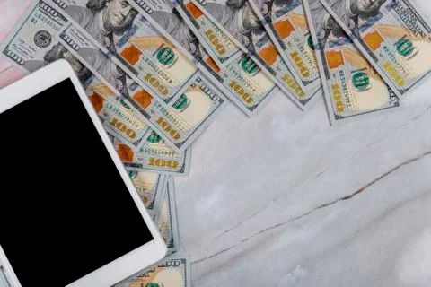 Dollar bills circle stack and digital devices tablet with technology and mone Stock Photos