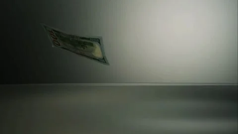 Dollar bills fall onto dark reflective floor Video stock 326751941