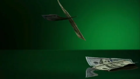 Dollar bills falling on green reflective surface Stock Footage 327051203