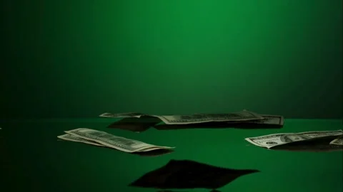 Dollar bills falling on a green surface Video stock 327180287