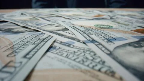 Dollar bills falling heap close up. Paper american currency scattering on table. Stock Photos