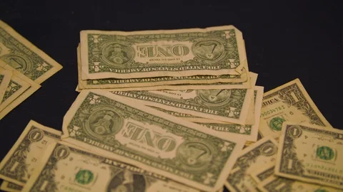 Dollar Bills Falling onto a Table Stock Footage 94159535