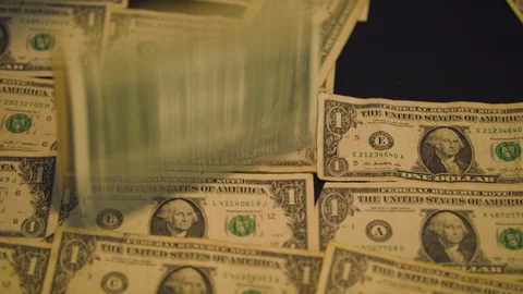 Dollar Bills Falling onto a Table Stock Footage 94159699