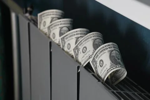 Dollar bills inserted into the radiator slots of the heating system, the incr Stock-Fotos