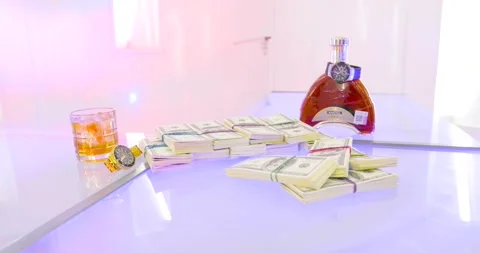 Dollar bills over a table with liqueur and clock watches Stock-Footage 155456314