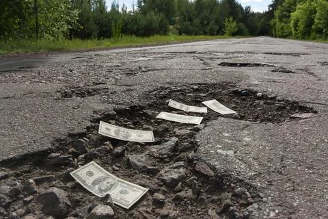 Dollar bills in potholes Stock Photos