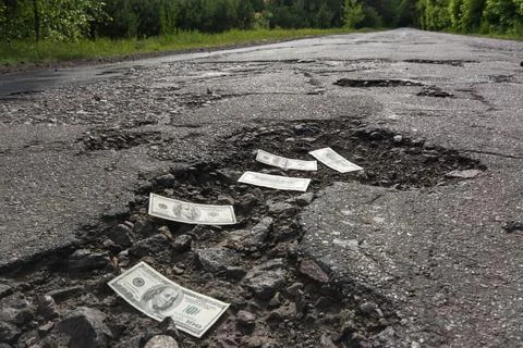 Dollar bills on road Stock Photos