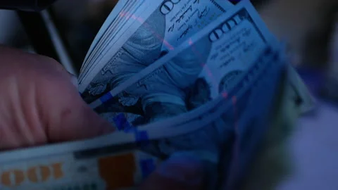 Dollar Bills in the ultraviolet light. Concept - checking dollars Stock Footage 169016034
