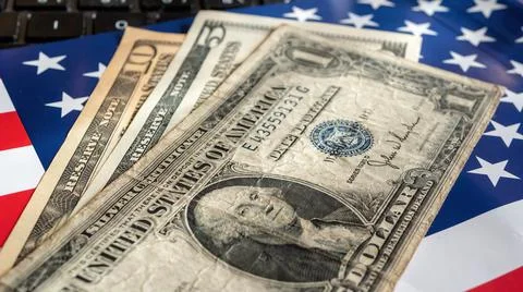 Dollar bills on US flag background Stock Photos