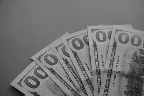 Dollar bills, on which only zeros are visible, peeking out of a large white e Foto stock