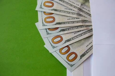Dollar bills, on which only zeros are visible, peeking out of a large white e Stock Photos