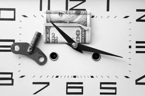 Dollar On A Clock Photos