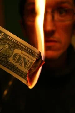 Dollar in Fire Stock Photos