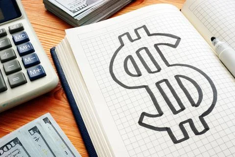 Dollar mark in the notepad and calculator. Savings and wealth concept. Stock Photos