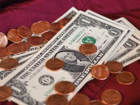 Dollar notes and coin, United States over red velvet background Stock Photos