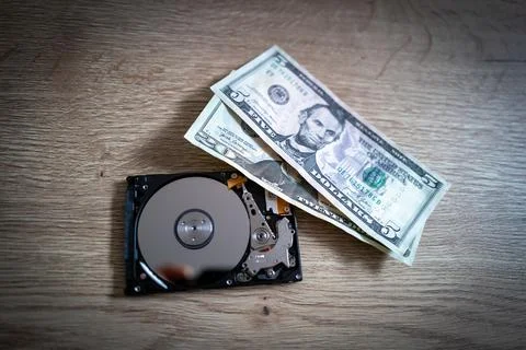 Dollar notes lie next to an open hard drive Foto stock