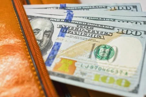 Dollar notes in a wallet, hundred-dollar bills are in a bag, Stock Photos