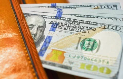 Dollar notes in a wallet, hundred-dollar bills are in a bag, Stock Photos